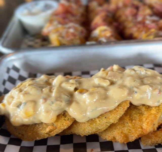 Fried green tomatoes topped with a creamy corn-pimento drizzle